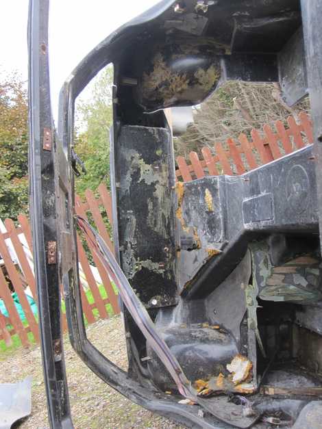 Cutting into the fiberglass body of a wrecked DeLorean to see if a backseat would fit.
